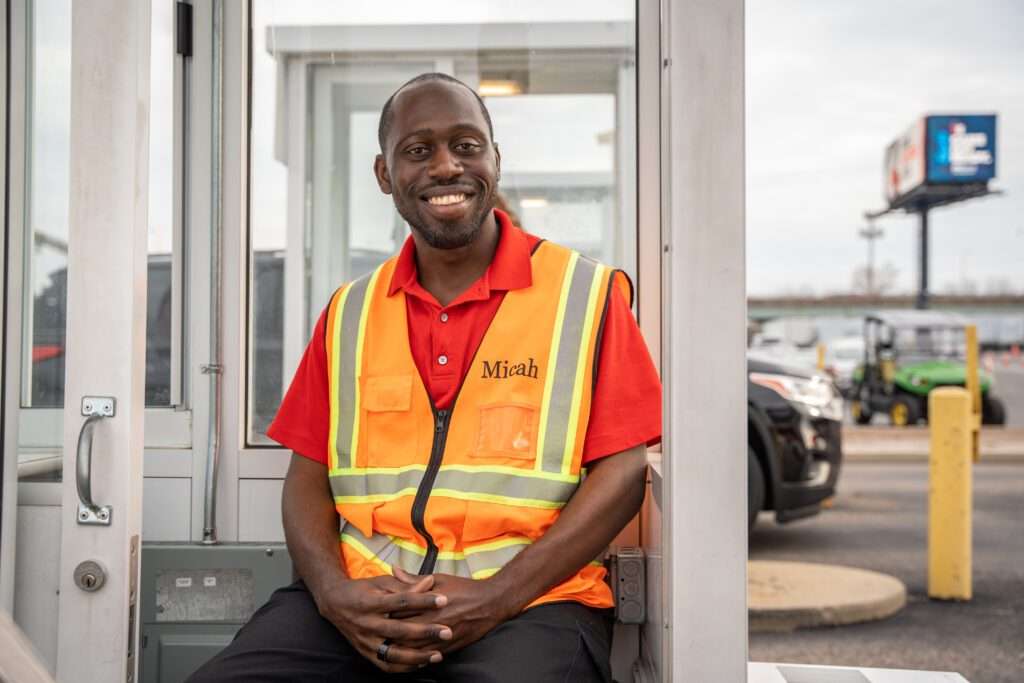 Happy SP+ employee at parking booth