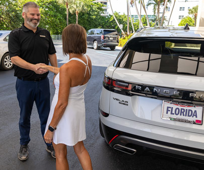 SP+ valet employee greeting customer outside hotel